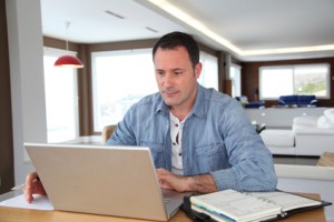 Man working at home on laptop computer