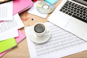 Cup of coffee on office desktop close-up