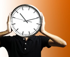 man holding clock