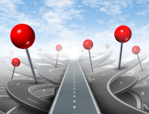 Direction Advice and choosing the right direct clear path to success with red push pins as confusing guides on the wrong roads as obstacles to financial wealth.